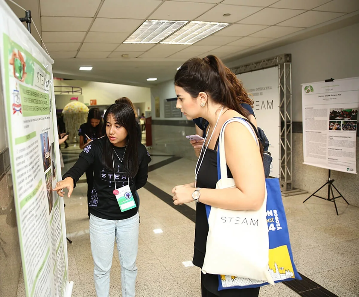 Participants talk in front of a scientific poster
